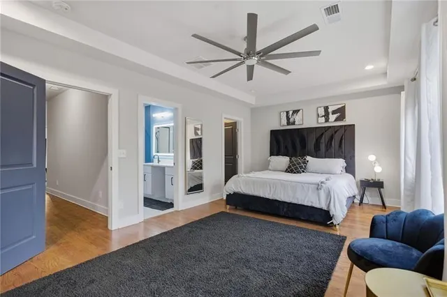 a spacious bedroom with a bed and ceiling fan