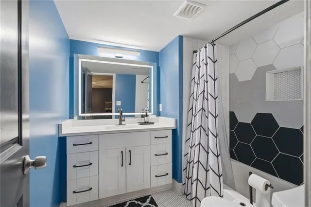 a bathroom with a mirror and a sink