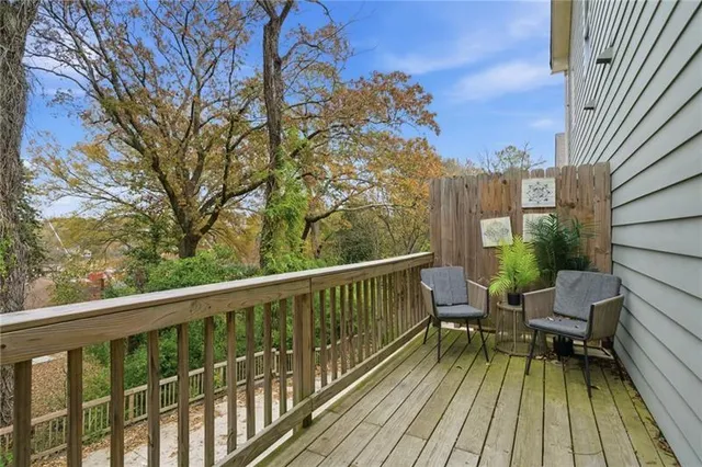 a view of balcony with wooden floor and outdoor seating