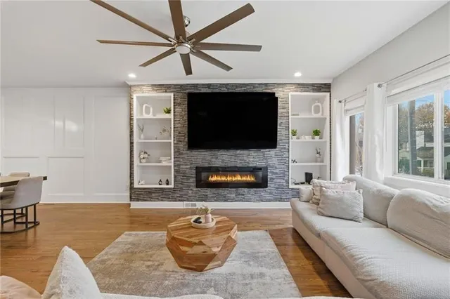 a living room with furniture a flat screen tv and a fireplace