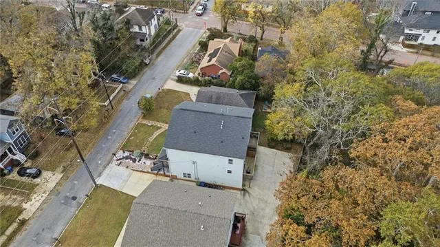 an aerial view of residential houses with outdoor space and parking