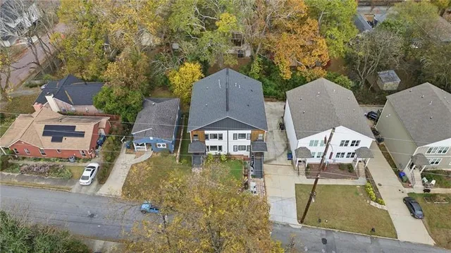 an aerial view of a house with a yard