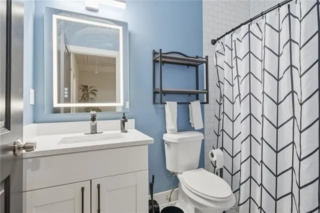 a bathroom with a toilet sink and mirror