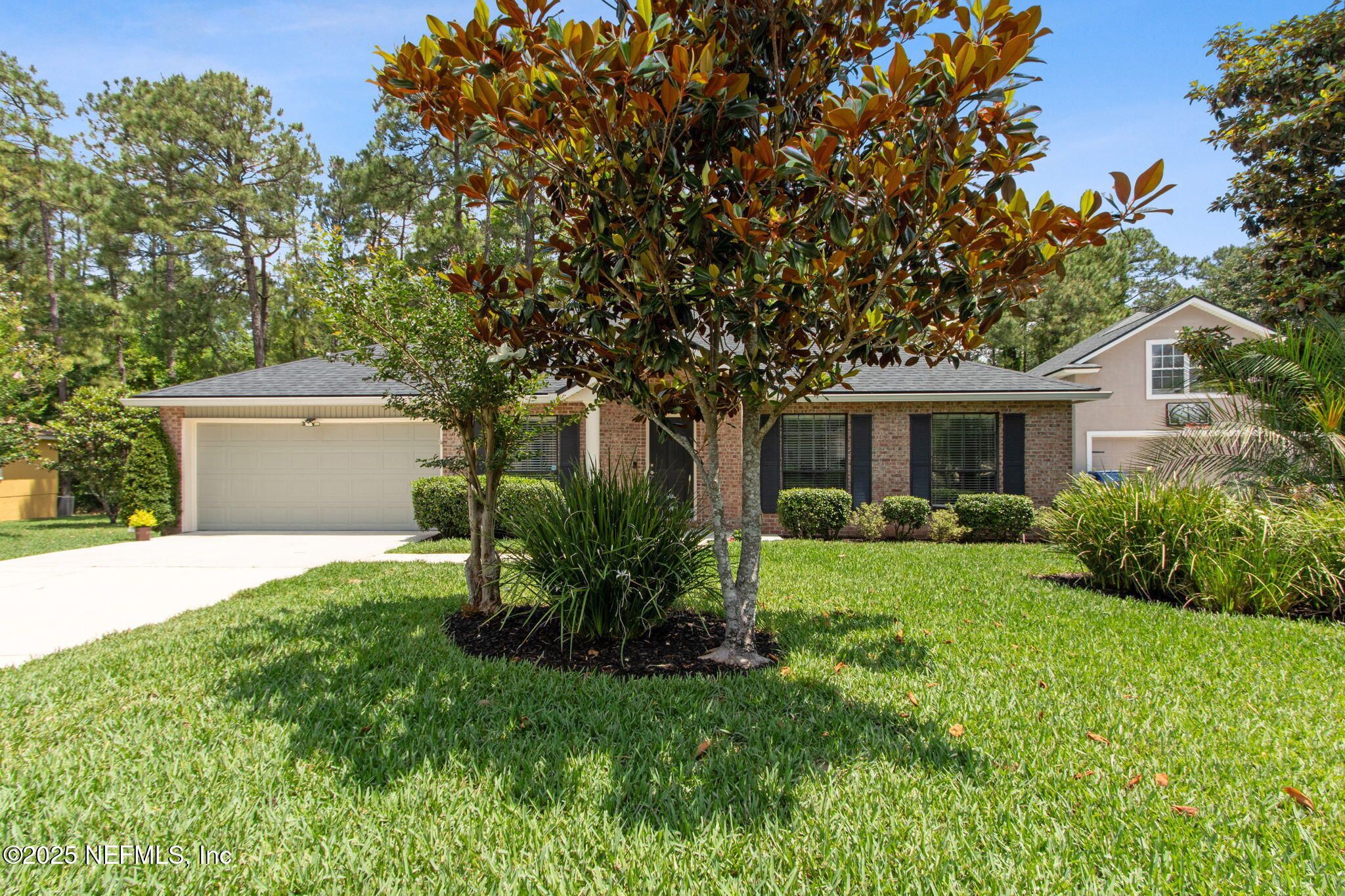 a front view of house with a garden