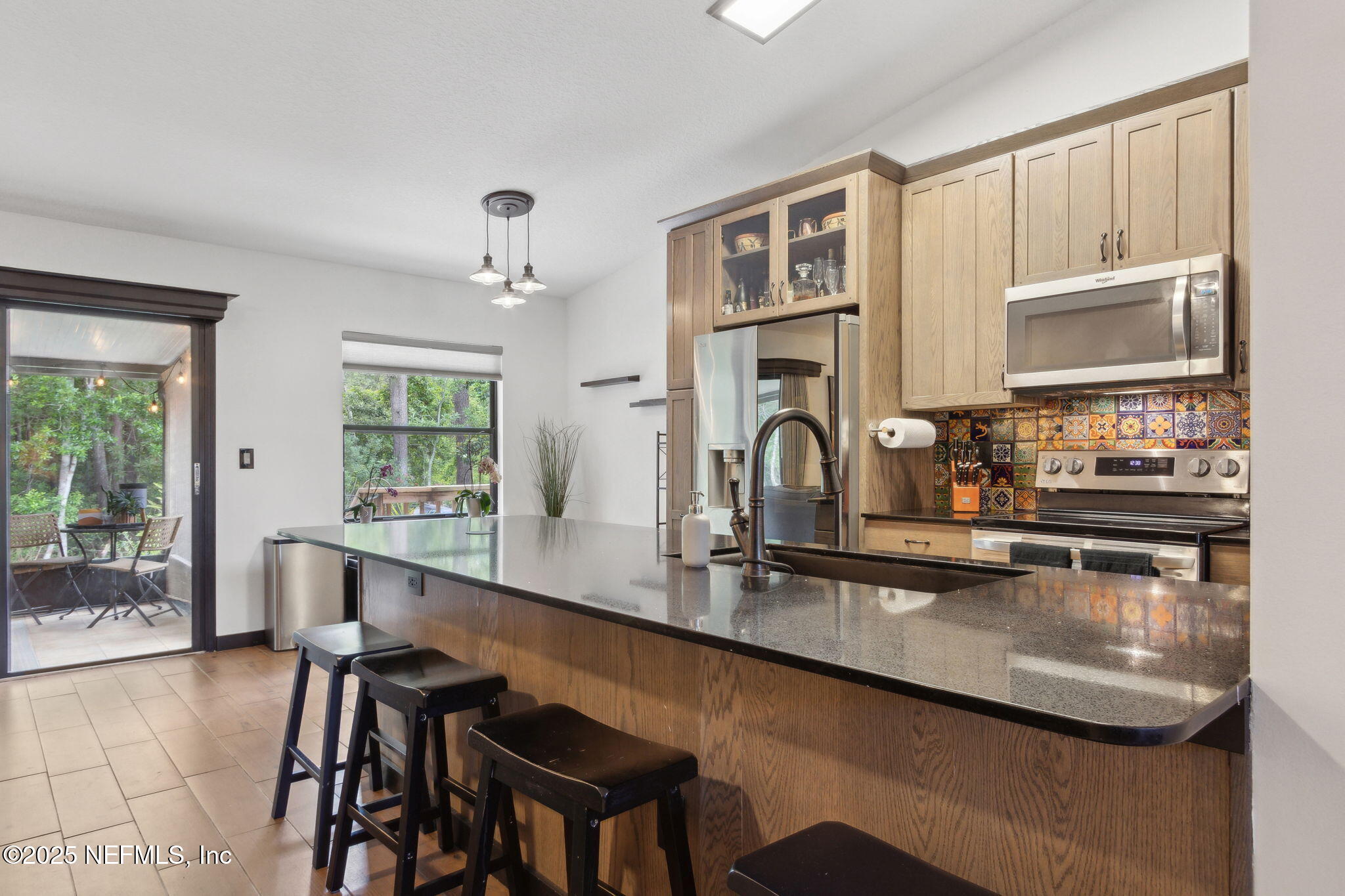 944 North Lilac Loop St. Johns, FL 32259 - Photo 11 of 55 a kitchen with kitchen island a stove a sink a dining table and chairs