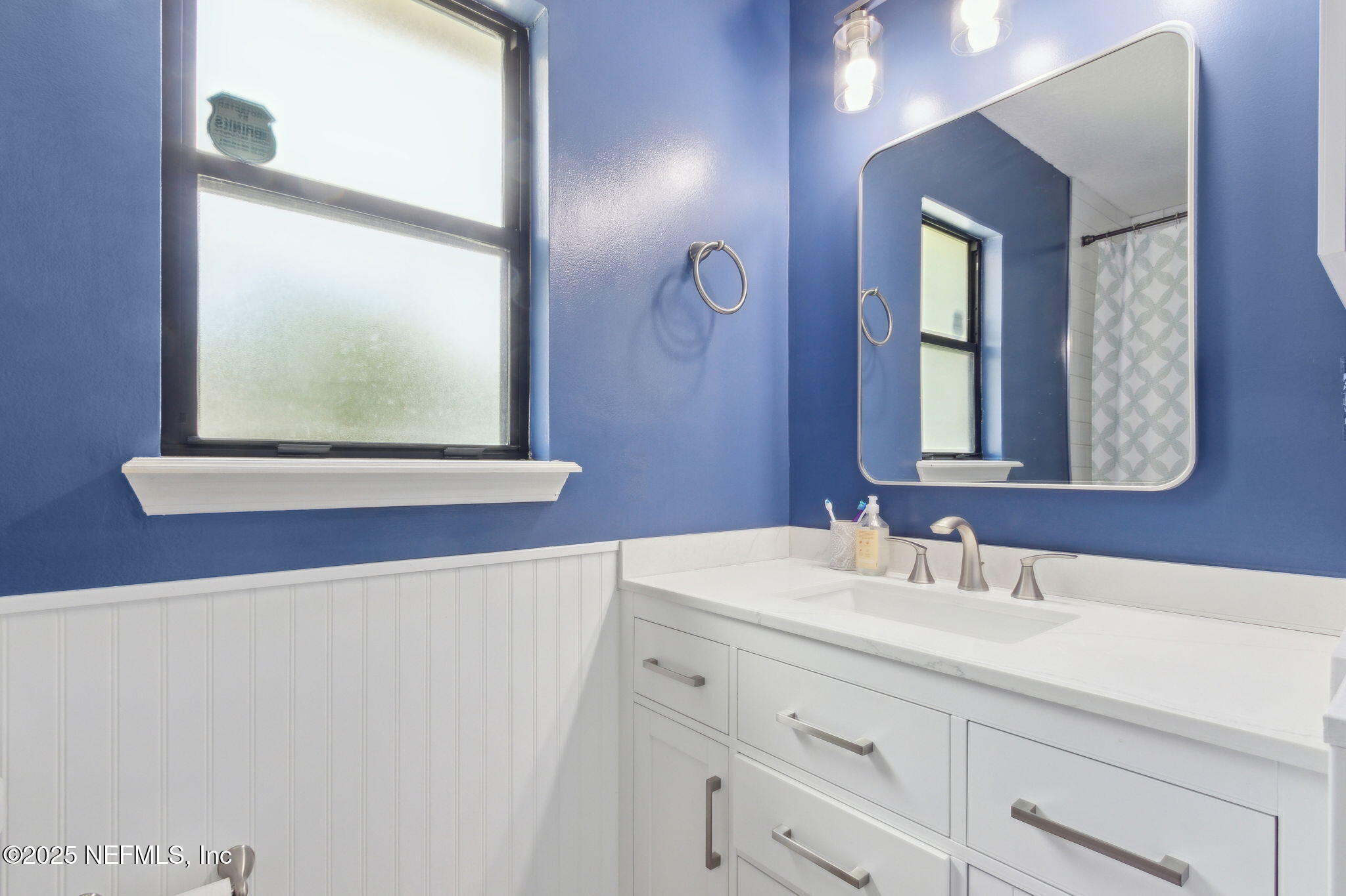 944 North Lilac Loop St. Johns, FL 32259 - Photo 26 of 55 a bathroom with a sink mirror and a window
