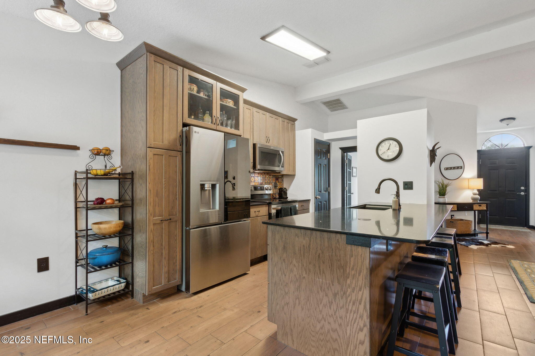 944 North Lilac Loop St. Johns, FL 32259 - Photo 10 of 55 a kitchen with stainless steel appliances granite countertop a refrigerator and a stove top oven