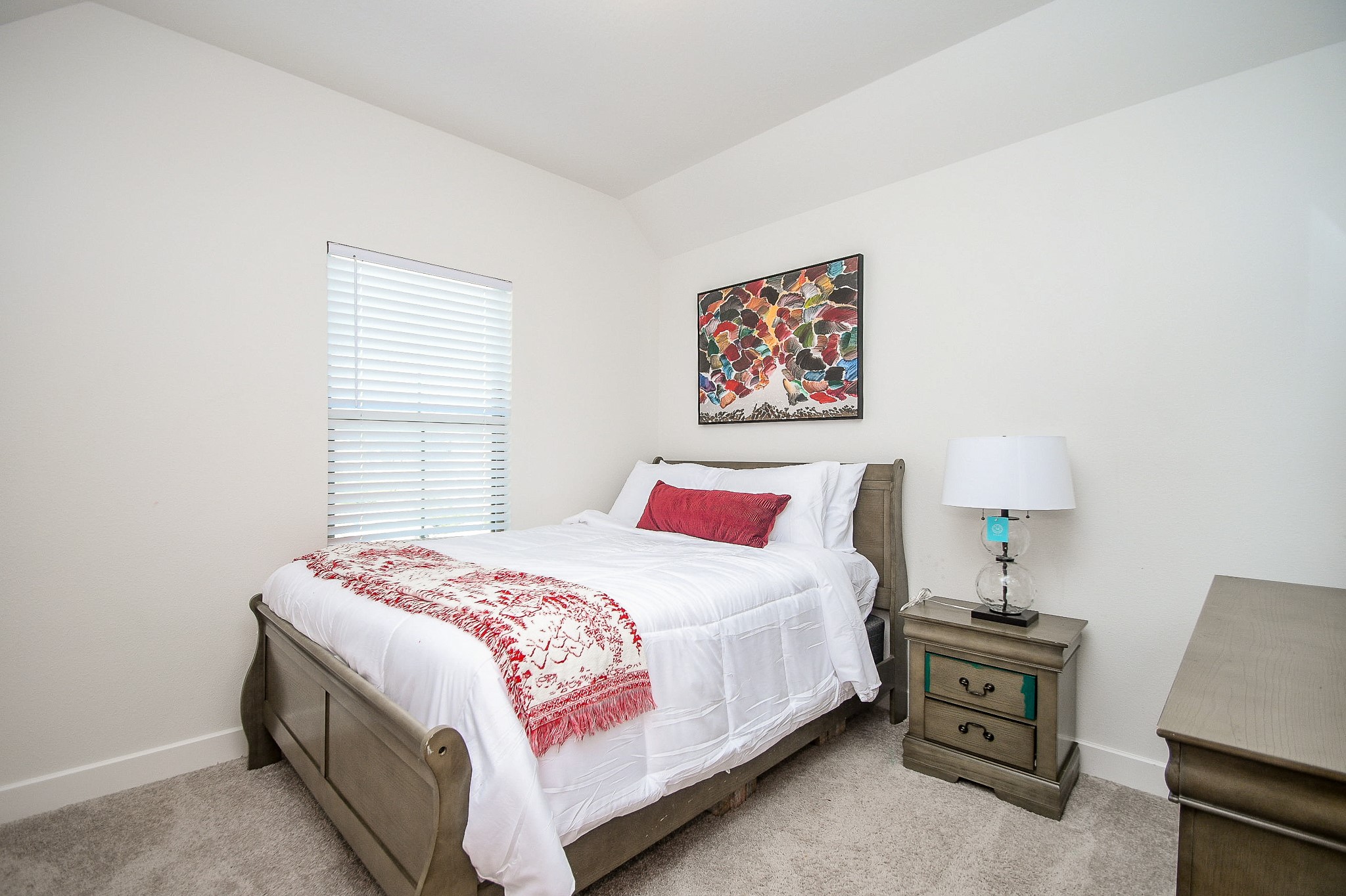 31407 Splitting Willow Lane Fulshear, TX 77441 - Photo 15 of 19 a bedroom with a bed and a lamp on dresser