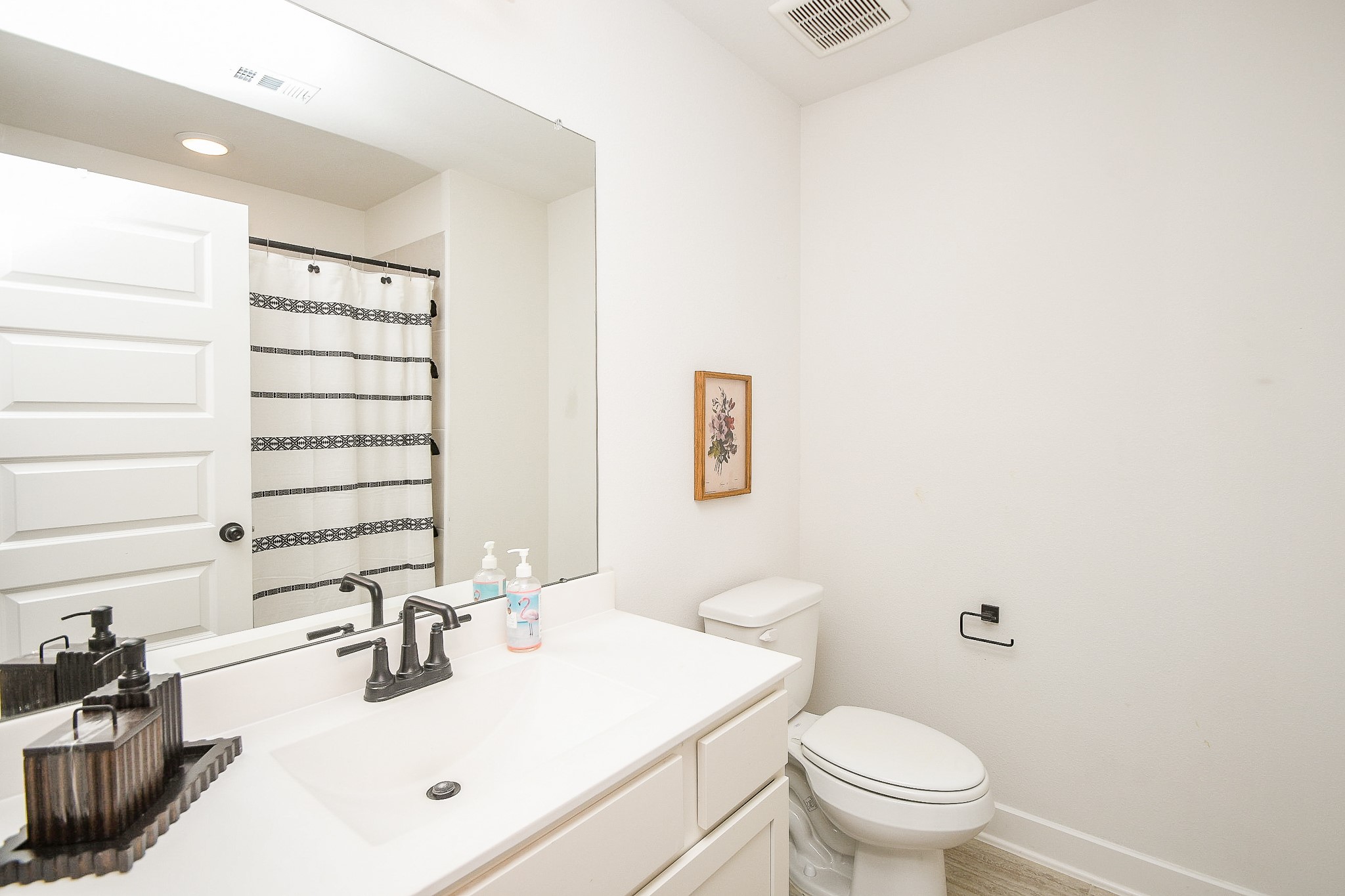 31407 Splitting Willow Lane Fulshear, TX 77441 - Photo 16 of 19 a bathroom with a sink toilet vanity and mirror