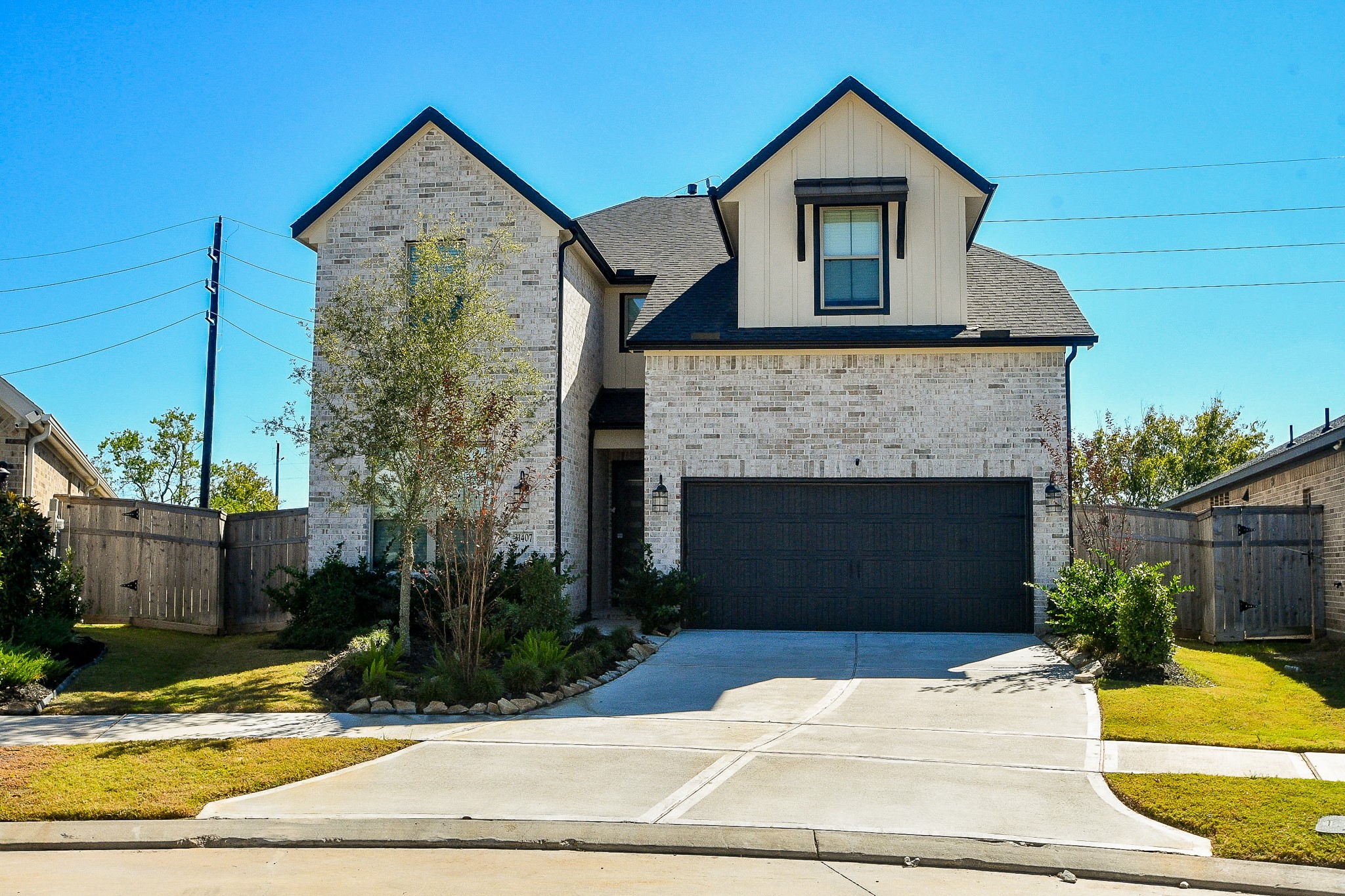31407 Splitting Willow Lane Fulshear, TX 77441 - Photo 3 of 19 a front view of a house with a yard and garage