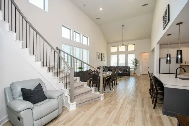 a living room with furniture dining table and a chandelier