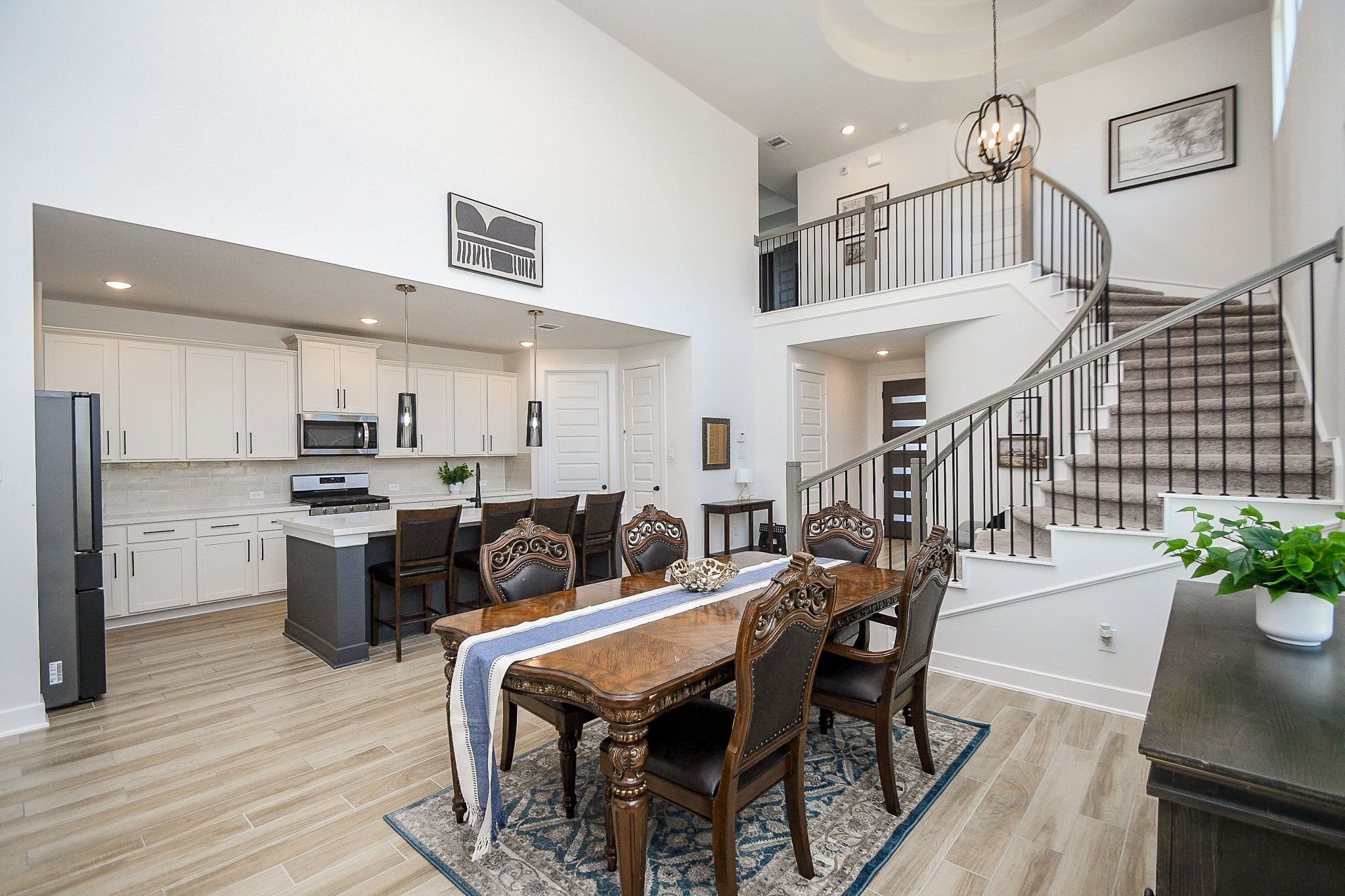 31407 Splitting Willow Lane Fulshear, TX 77441 - Photo 9 of 19 a kitchen with a table chairs stainless steel appliances and cabinets