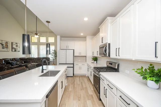 a kitchen with a sink stove and refrigerator