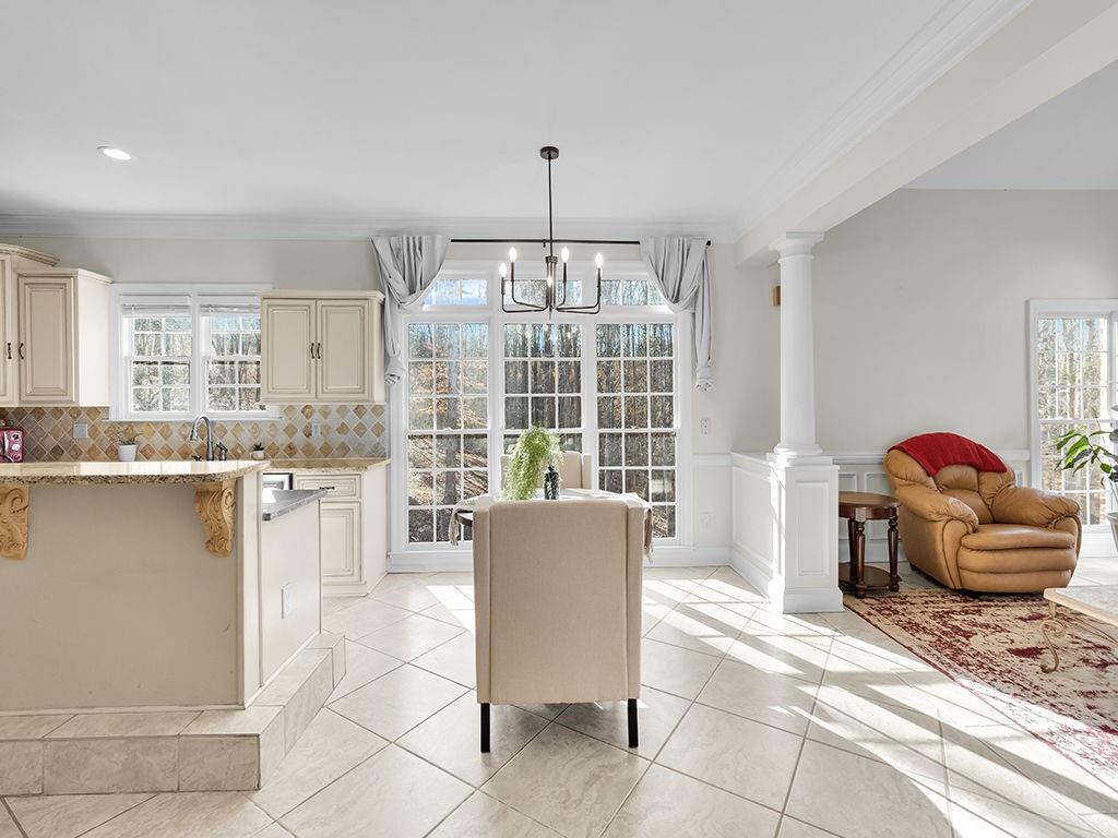 129 Preserve Parkway Ball Ground, GA 30107 - Photo 12 of 76 a living room with furniture and a floor to ceiling window
