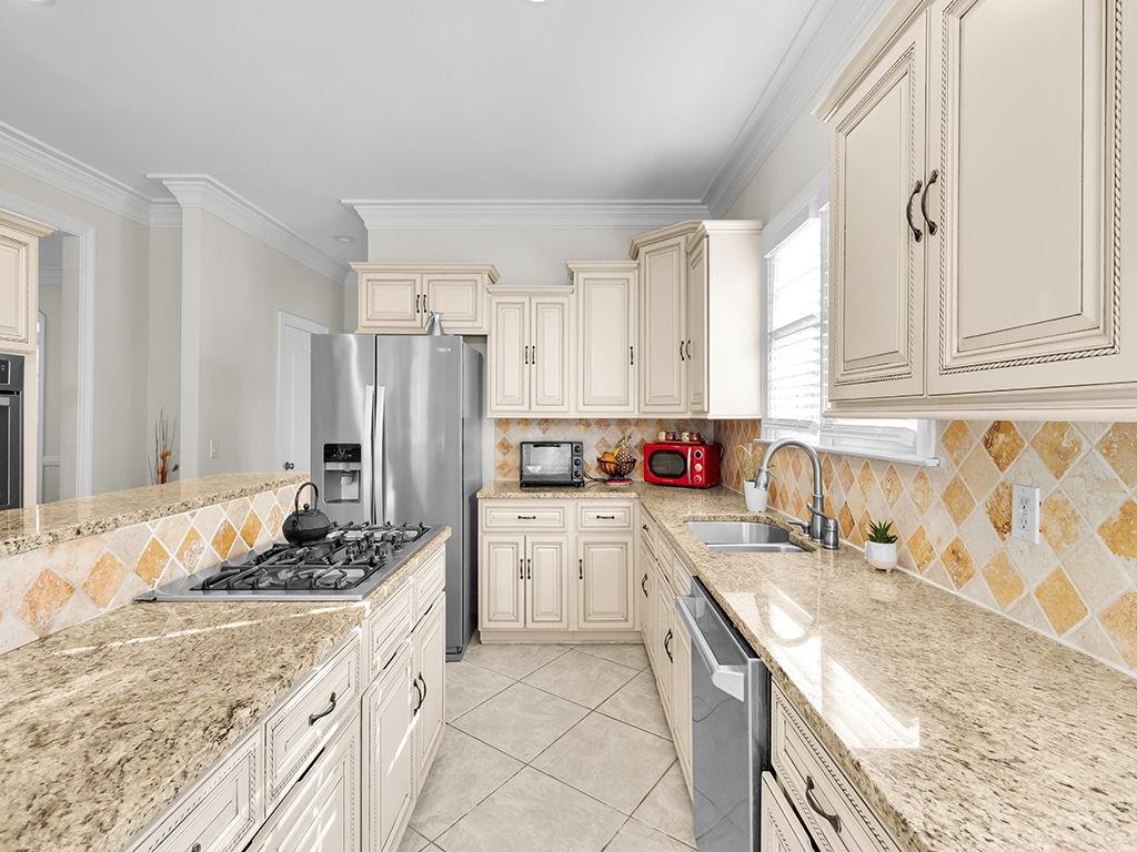 129 Preserve Parkway Ball Ground, GA 30107 - Photo 15 of 76 a kitchen with granite countertop a sink stove and refrigerator
