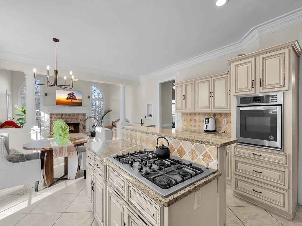 129 Preserve Parkway Ball Ground, GA 30107 - Photo 16 of 76 a kitchen with stainless steel appliances granite countertop a stove a sink dishwasher and a microwave