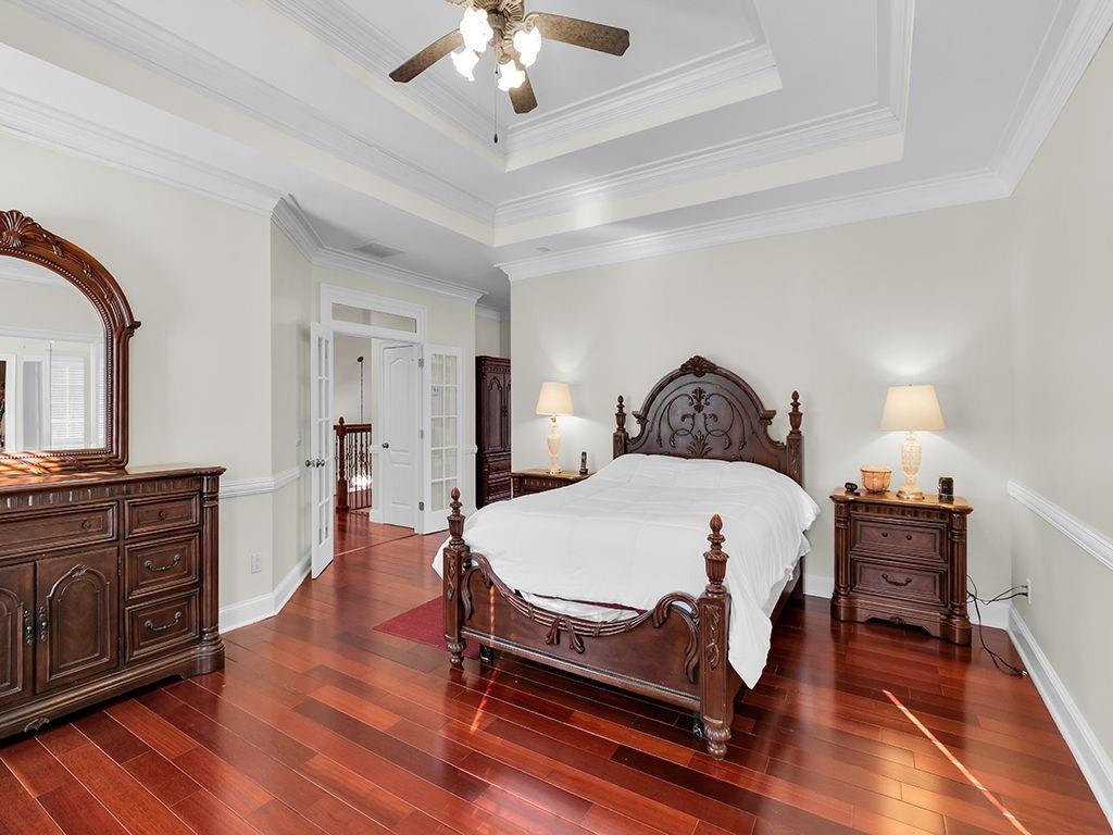 129 Preserve Parkway Ball Ground, GA 30107 - Photo 27 of 76 a spacious bedroom with a bed and a chandelier
