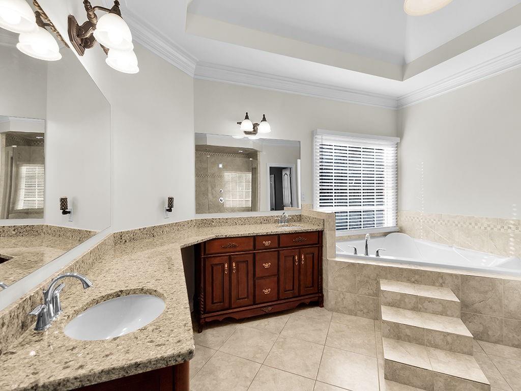 129 Preserve Parkway Ball Ground, GA 30107 - Photo 33 of 76 a bathroom with a granite countertop bathtub sink and mirror