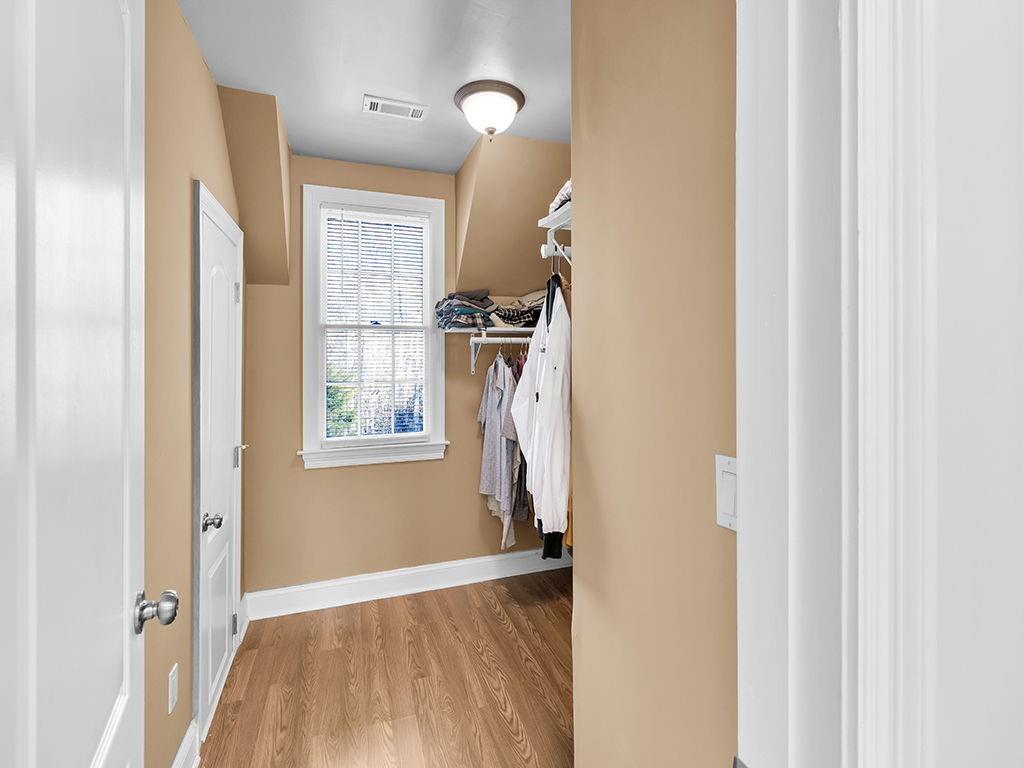 129 Preserve Parkway Ball Ground, GA 30107 - Photo 36 of 76 a view of hallway with wooden floor and stairs