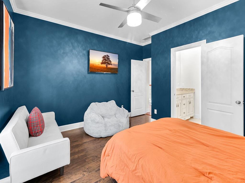 129 Preserve Parkway Ball Ground, GA 30107 - Photo 39 of 76 a bedroom with two beds and a chandelier