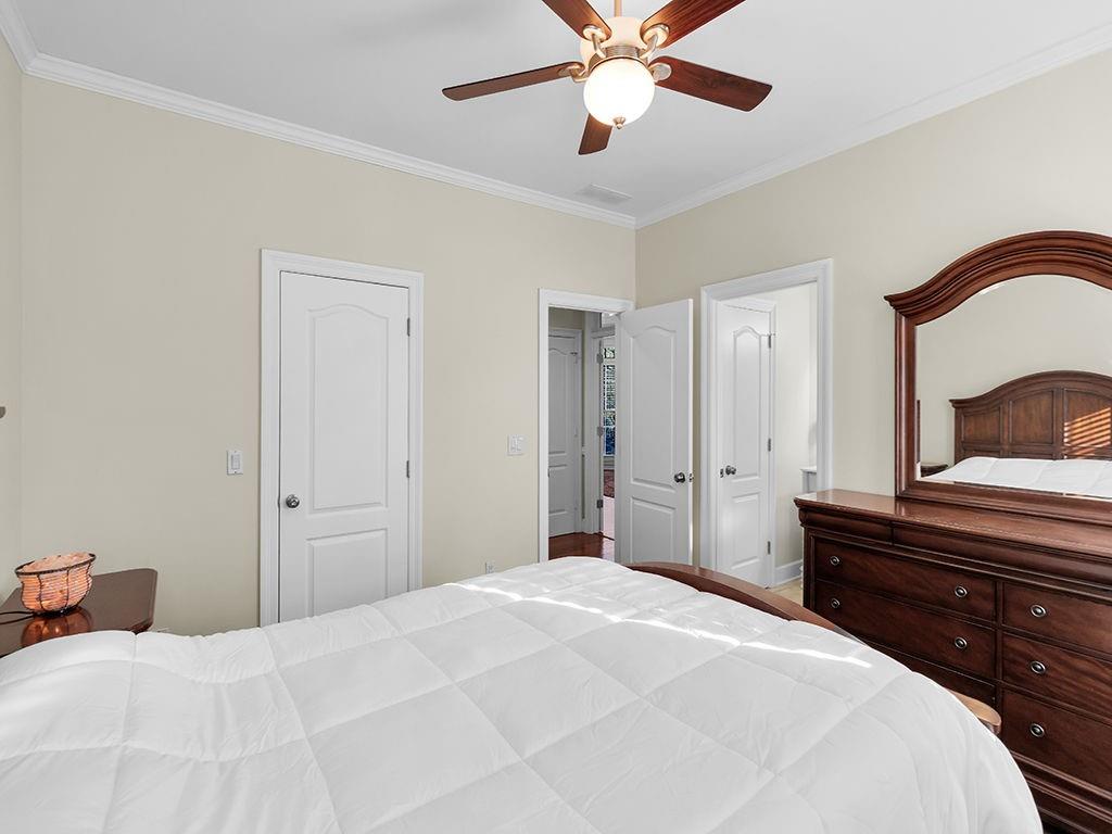 129 Preserve Parkway Ball Ground, GA 30107 - Photo 43 of 76 a bedroom with a bed and a chandelier