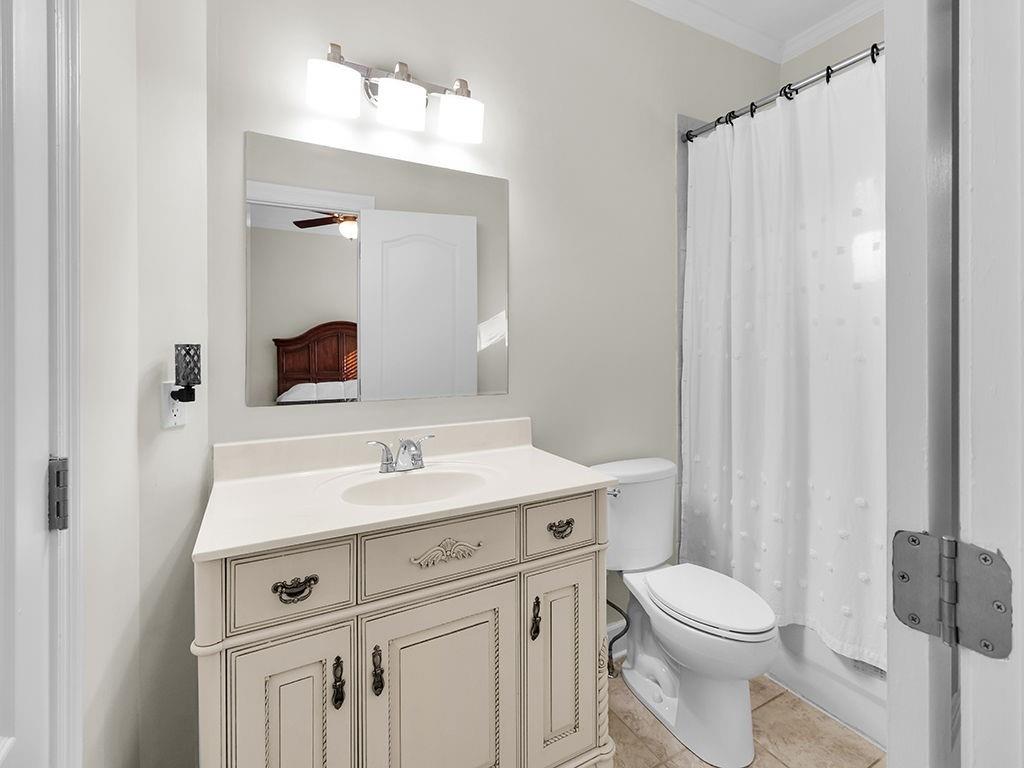 129 Preserve Parkway Ball Ground, GA 30107 - Photo 44 of 76 a bathroom with a sink a toilet a mirror and shower curtain