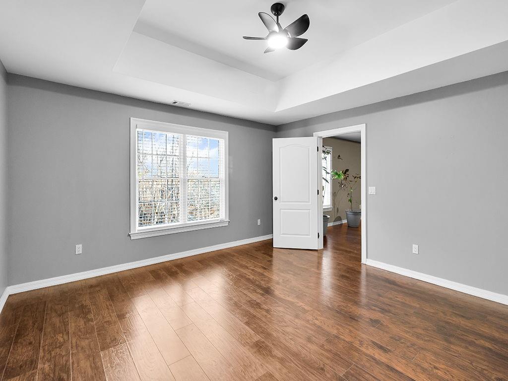129 Preserve Parkway Ball Ground, GA 30107 - Photo 45 of 76 an empty room with wooden floor and windows