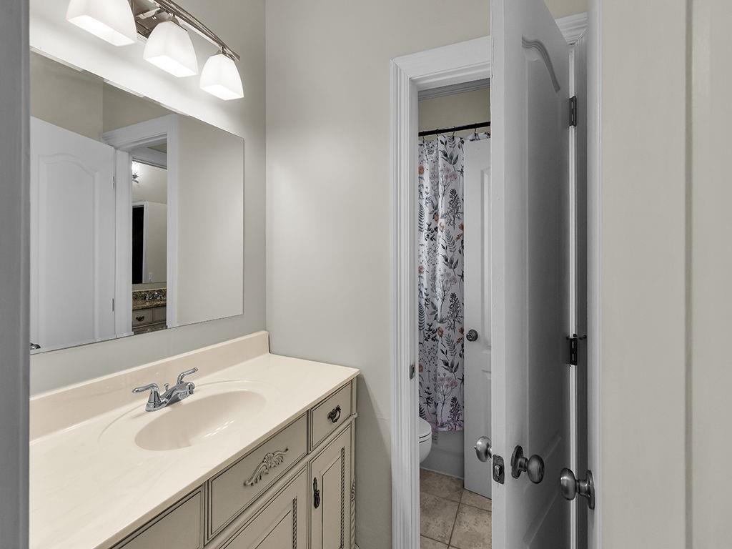 129 Preserve Parkway Ball Ground, GA 30107 - Photo 46 of 76 a bathroom with a sink a mirror a vanity and a shower