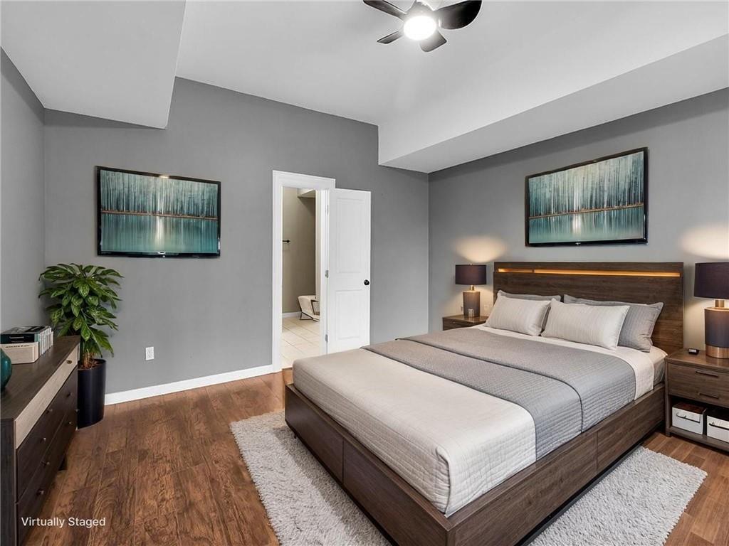 129 Preserve Parkway Ball Ground, GA 30107 - Photo 47 of 76 a bedroom with bed and a painting on the wall