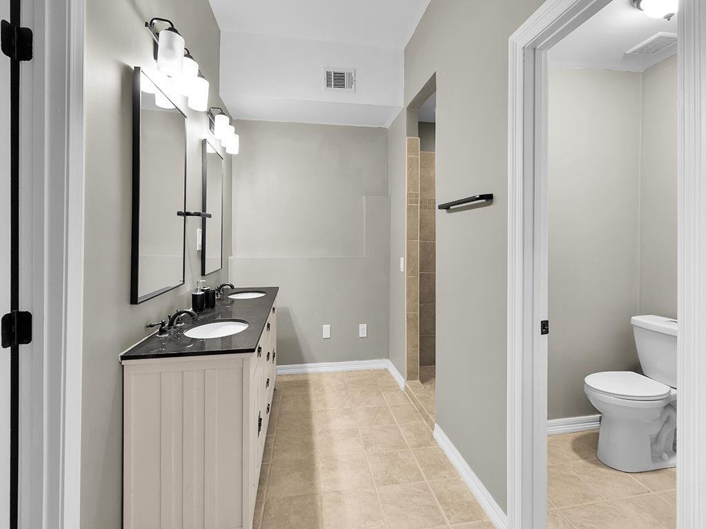 129 Preserve Parkway Ball Ground, GA 30107 - Photo 50 of 76 a bathroom with a sink a toilet and shower