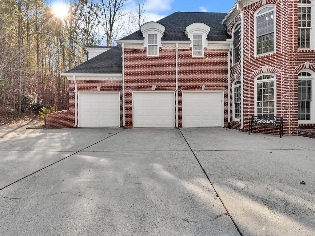 129 Preserve Parkway Ball Ground, GA 30107 - Photo 5 of 76 a view of a brick house with many windows