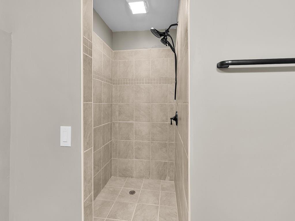 129 Preserve Parkway Ball Ground, GA 30107 - Photo 51 of 76 a bathroom with a glass shower door
