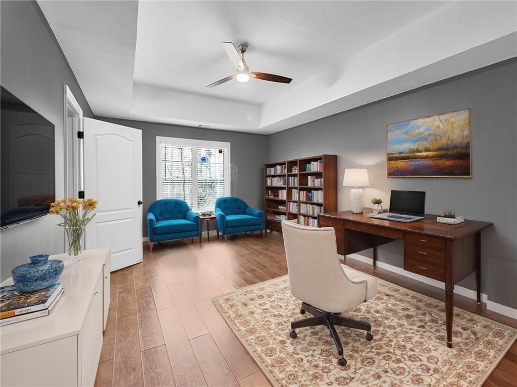 129 Preserve Parkway Ball Ground, GA 30107 - Photo 52 of 76 a work room with furniture a rug and a flat screen tv