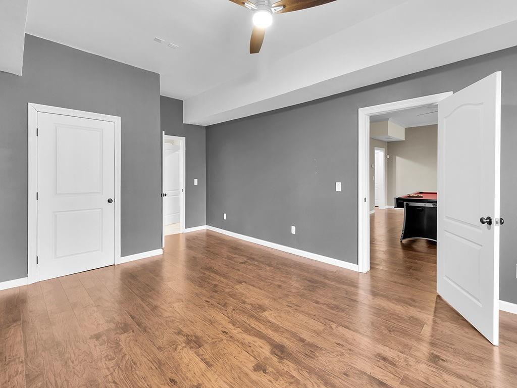 129 Preserve Parkway Ball Ground, GA 30107 - Photo 53 of 76 wooden floor in an empty room with a window