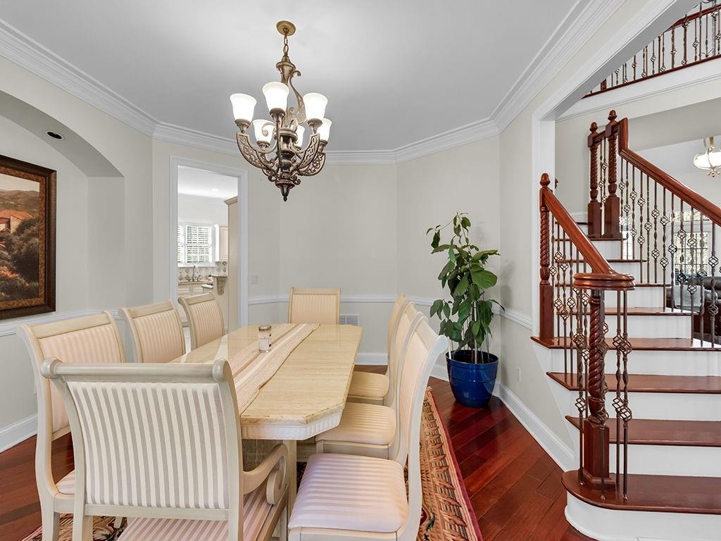 129 Preserve Parkway Ball Ground, GA 30107 - Photo 8 of 76 a view of a dining room with furniture wooden floor and chandelier