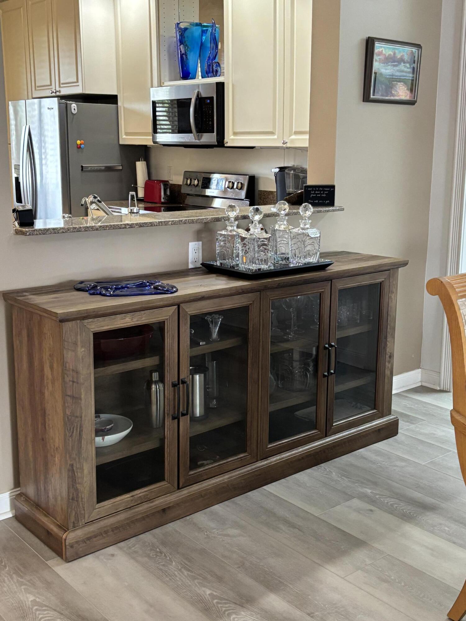 9 Harbour Isle Drive East, Unit 102 Fort Pierce, FL 34949 - Photo 11 of 30 a kitchen with stainless steel appliances granite countertop a stove and a microwave