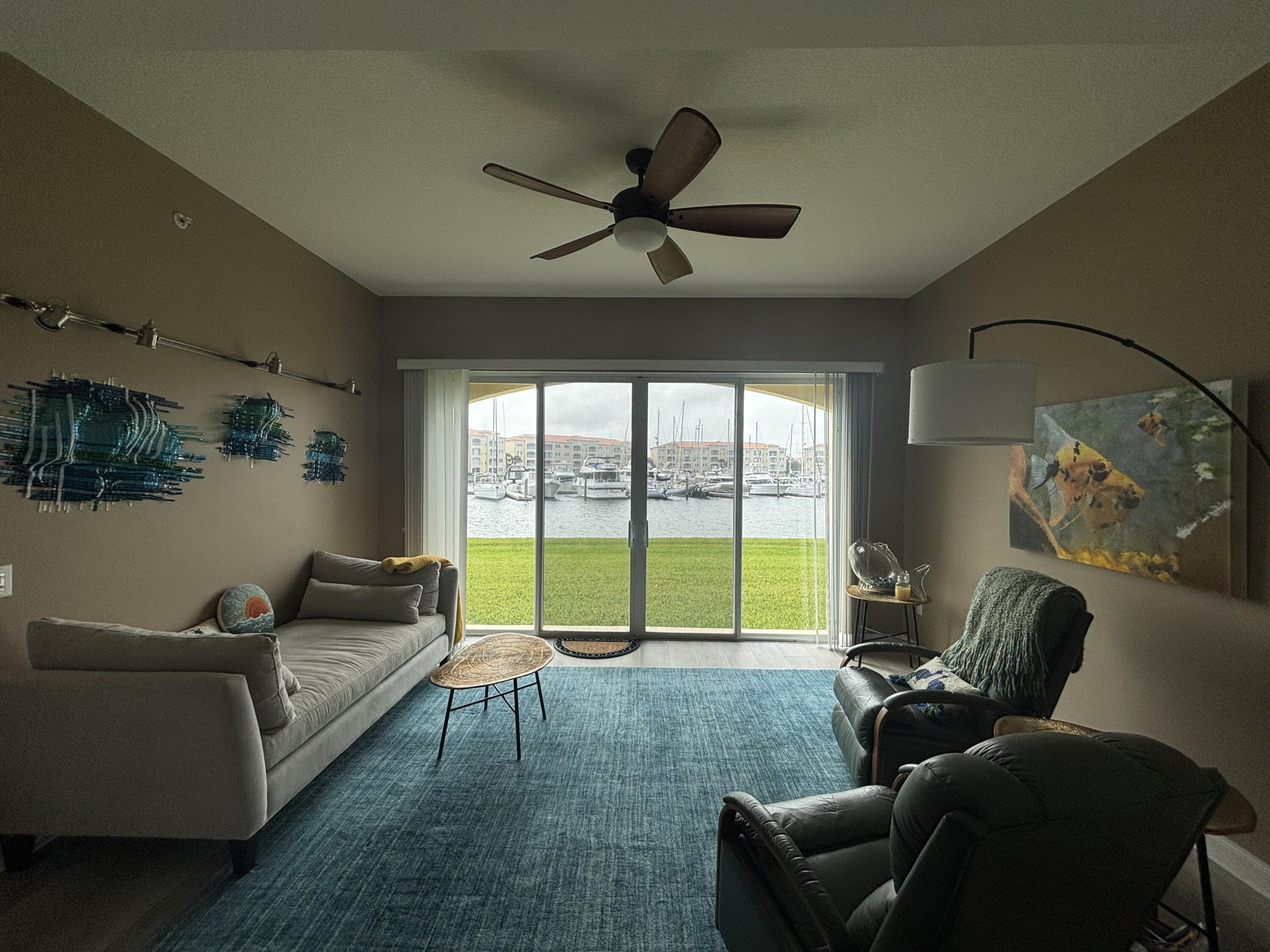 9 Harbour Isle Drive East, Unit 102 Fort Pierce, FL 34949 - Photo 16 of 30 a living room with furniture and a floor to ceiling window