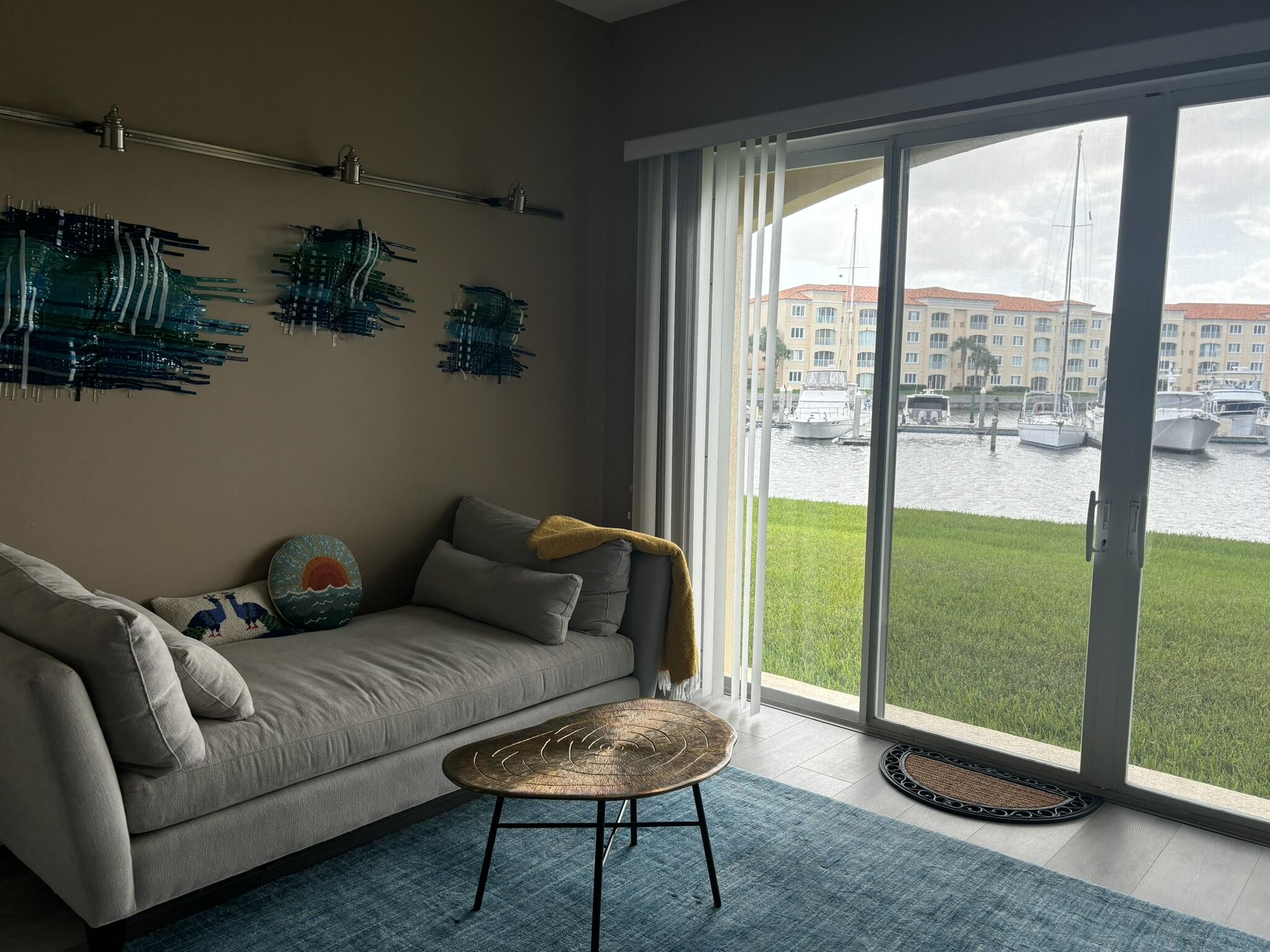 9 Harbour Isle Drive East, Unit 102 Fort Pierce, FL 34949 - Photo 17 of 30 a living room with furniture and a floor to ceiling window
