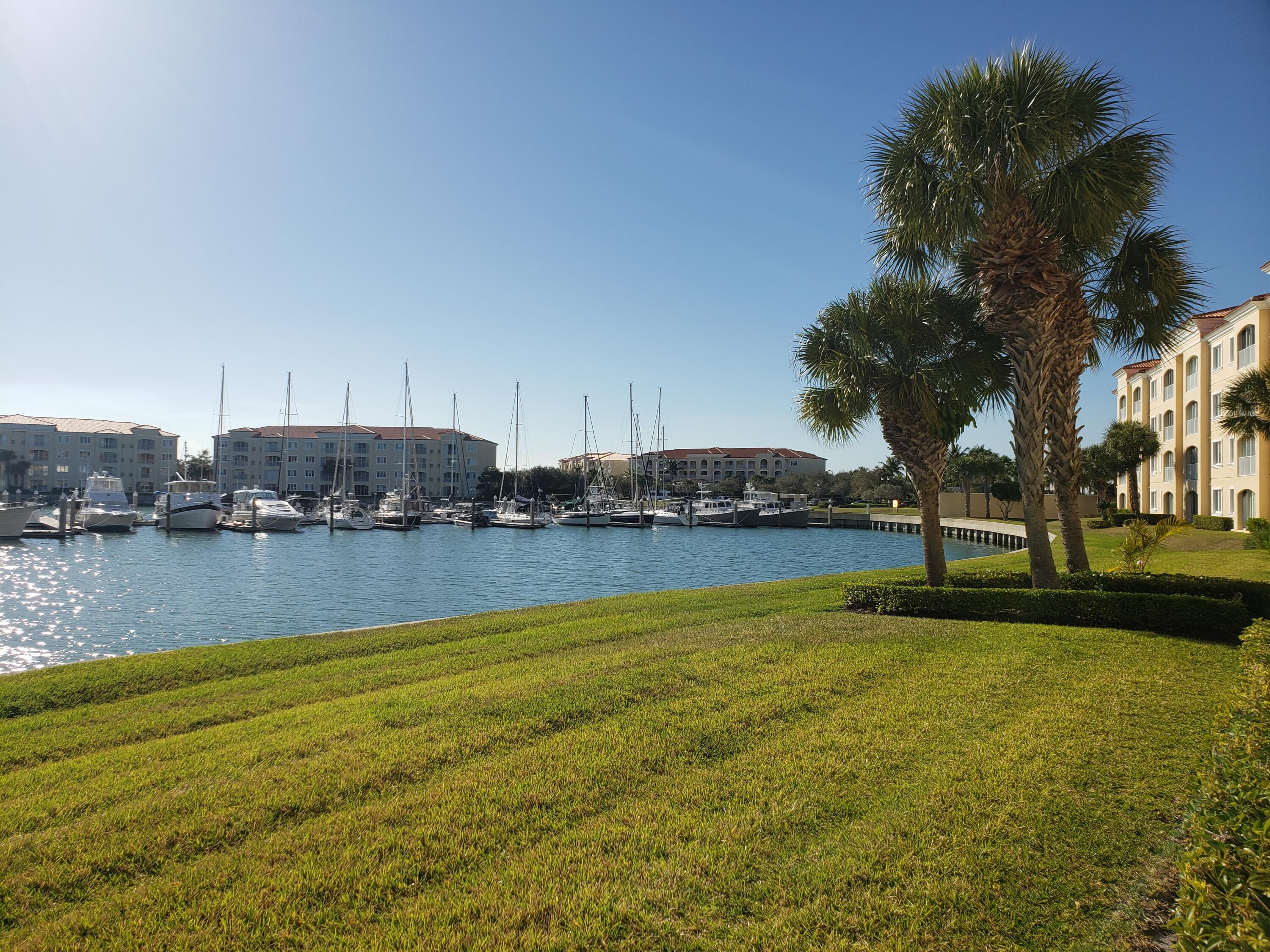 9 Harbour Isle Drive East, Unit 102 Fort Pierce, FL 34949 - Photo 20 of 30 a view of a lake with houses in the background
