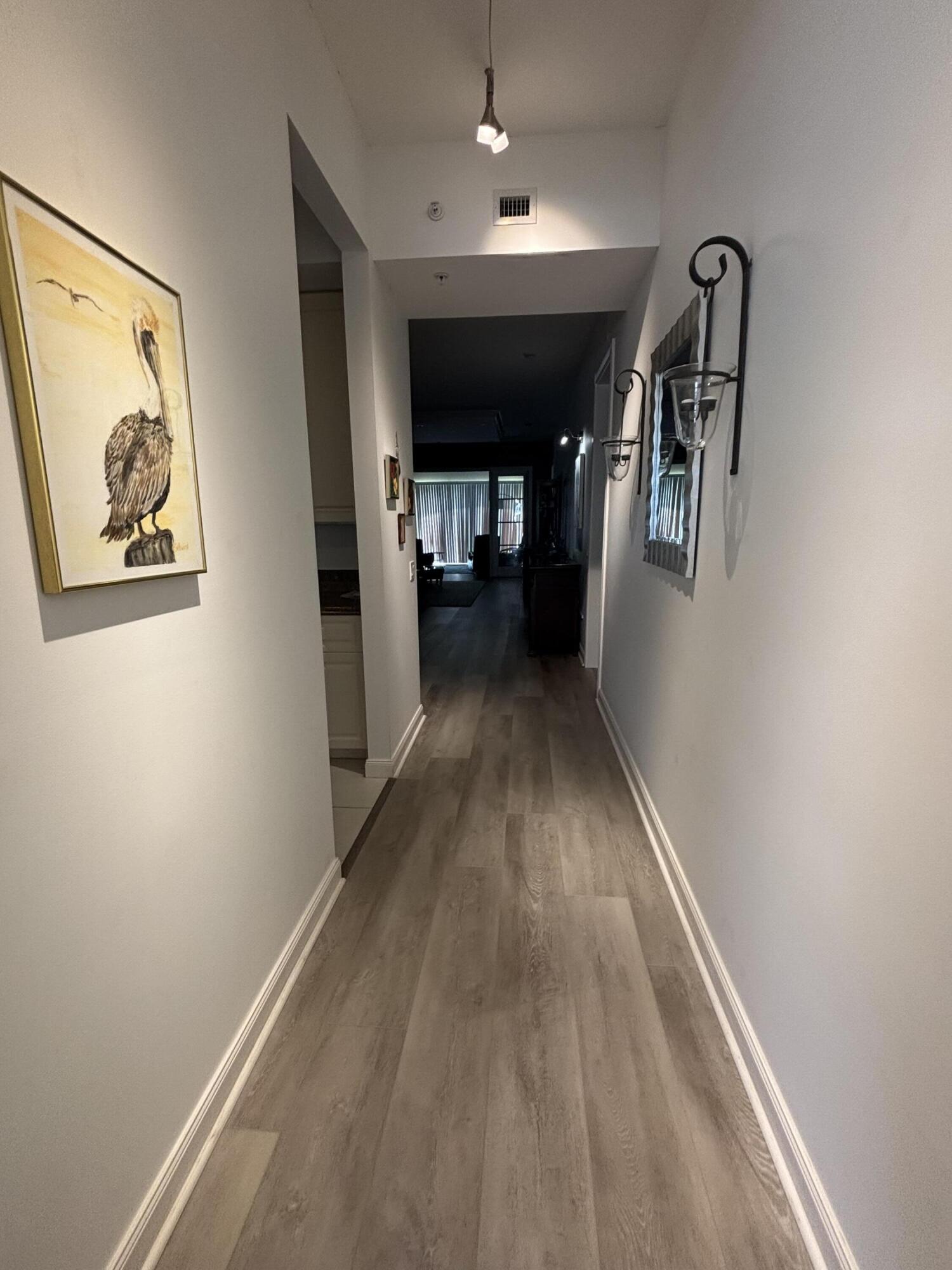 9 Harbour Isle Drive East, Unit 102 Fort Pierce, FL 34949 - Photo 2 of 30 a view of a hallway with wooden floor