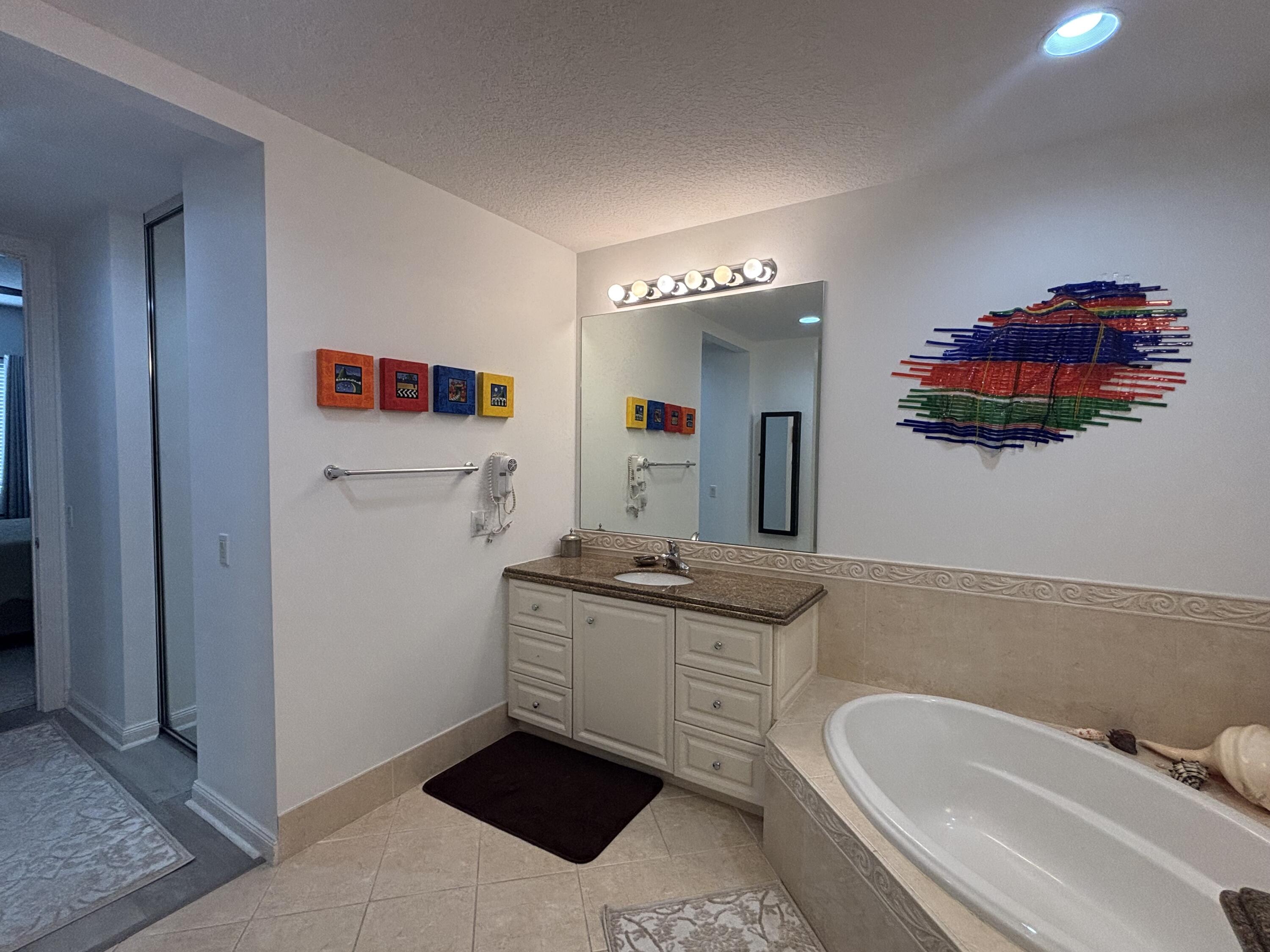 9 Harbour Isle Drive East, Unit 102 Fort Pierce, FL 34949 - Photo 21 of 30 a bathroom with a sink and a mirror