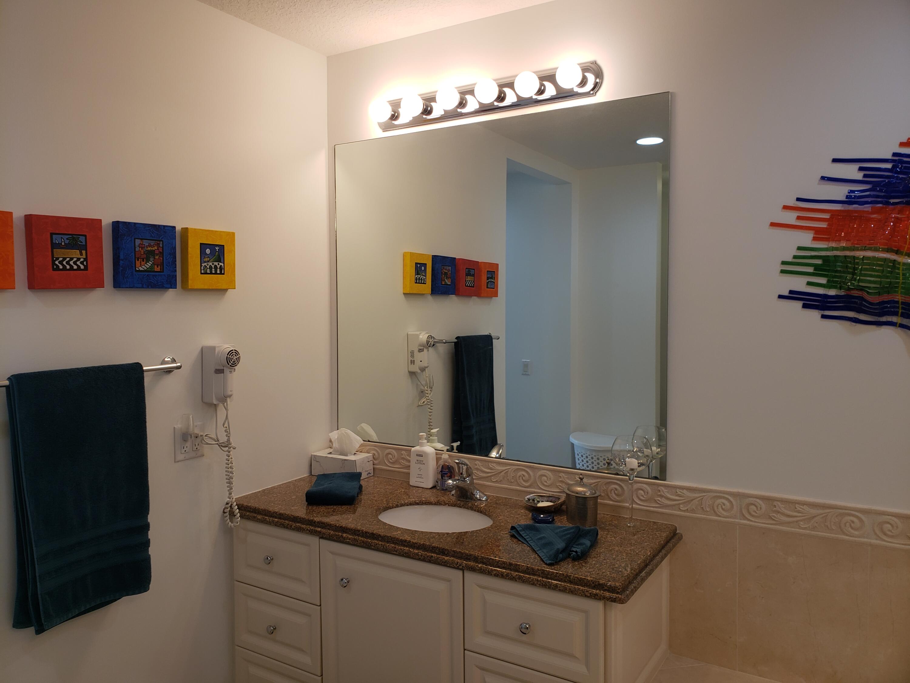 9 Harbour Isle Drive East, Unit 102 Fort Pierce, FL 34949 - Photo 22 of 30 a bathroom with a sink and a mirror
