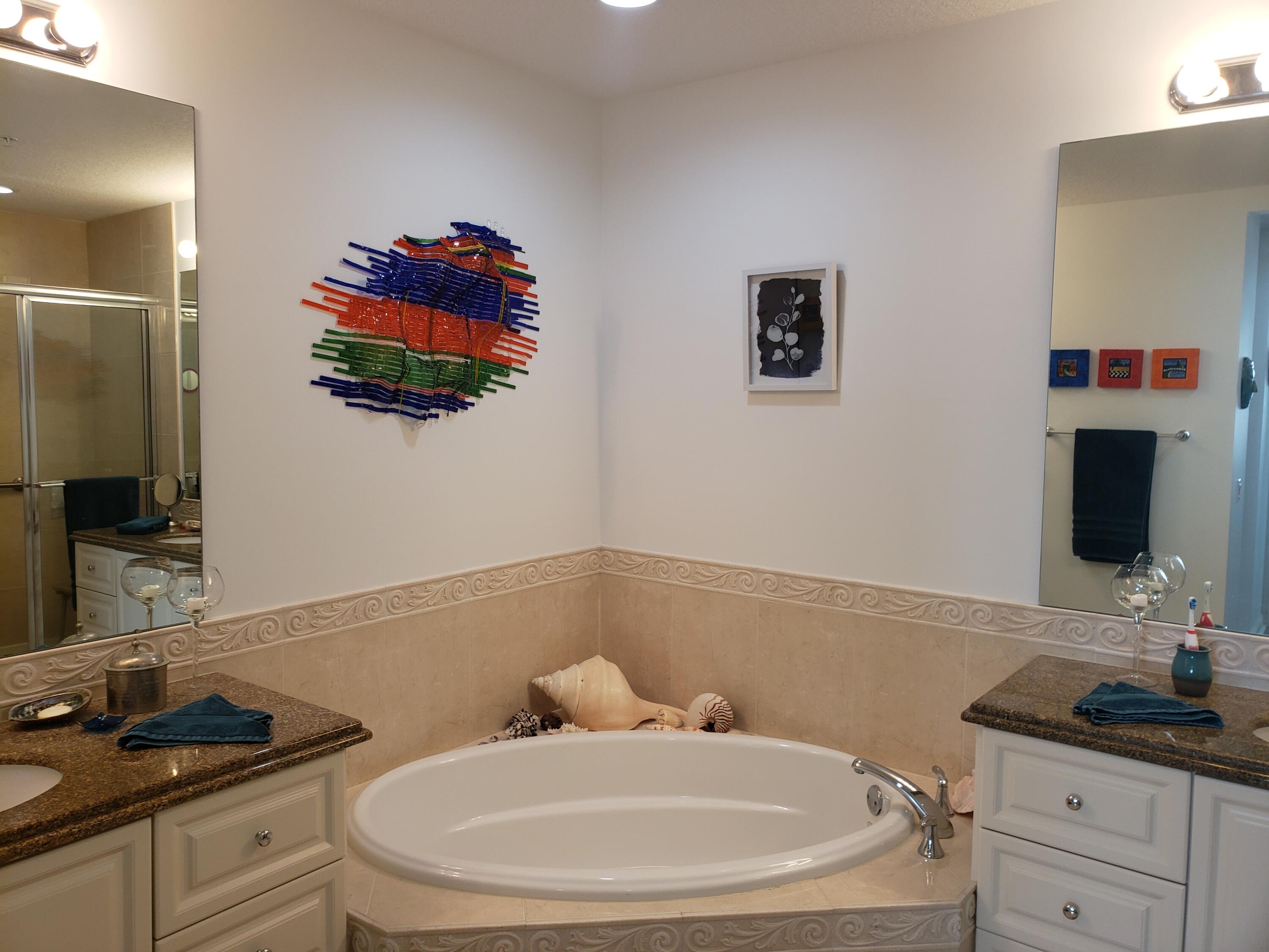 9 Harbour Isle Drive East, Unit 102 Fort Pierce, FL 34949 - Photo 24 of 30 a bathroom with a sink and a mirror