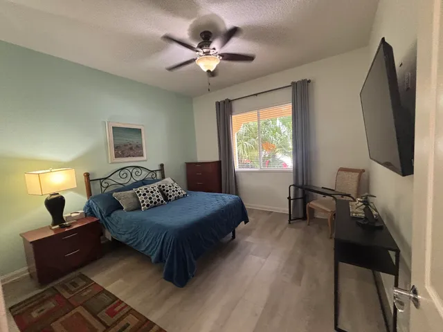 a bedroom with a bed lamp and a fireplace