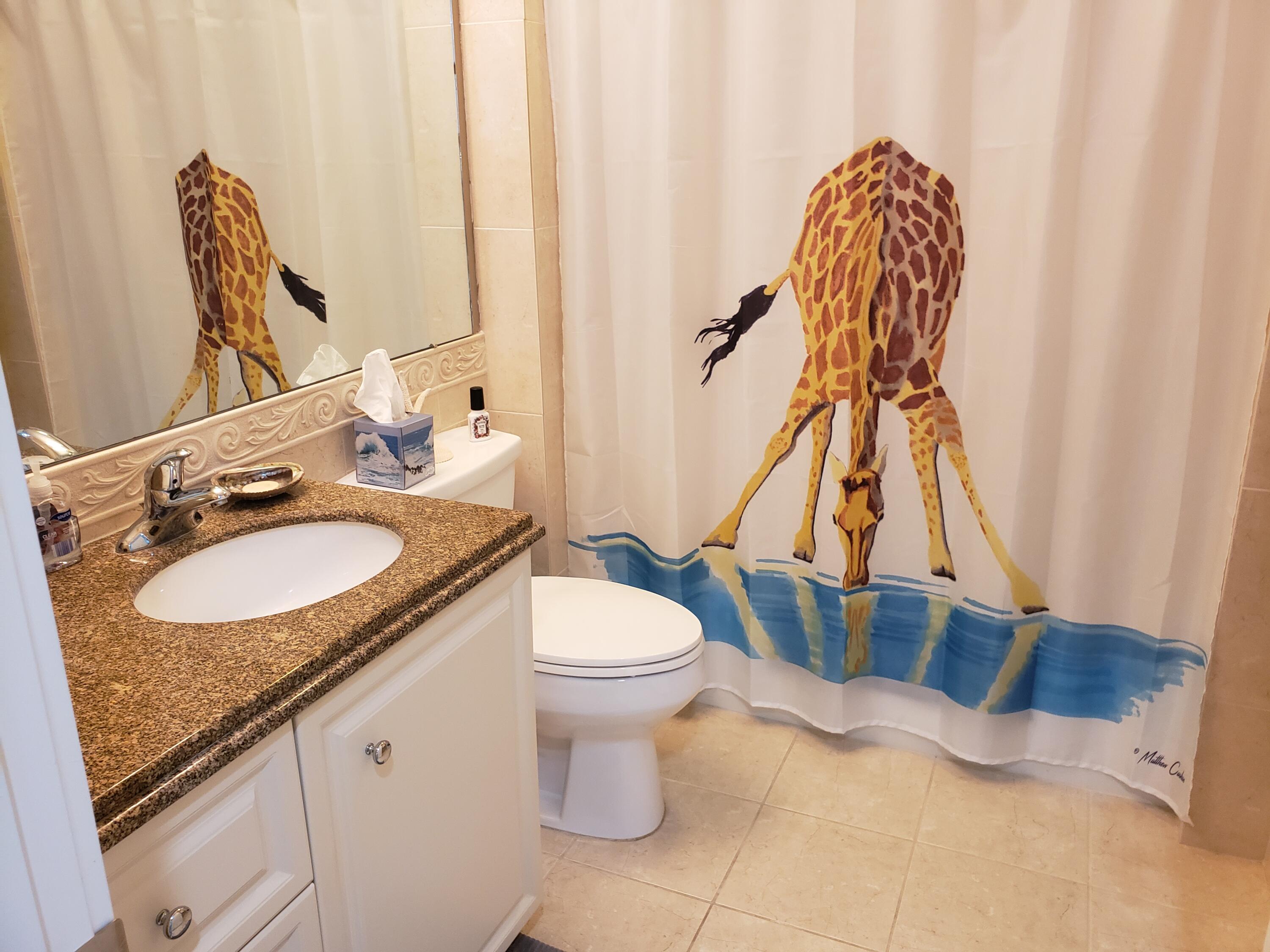 9 Harbour Isle Drive East, Unit 102 Fort Pierce, FL 34949 - Photo 26 of 30 a bathroom with a granite countertop sink and a mirror