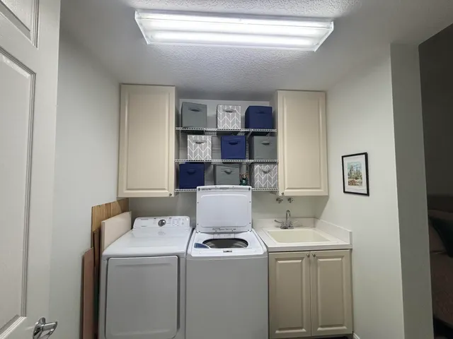 a view of storage and utility room with washer and dryer