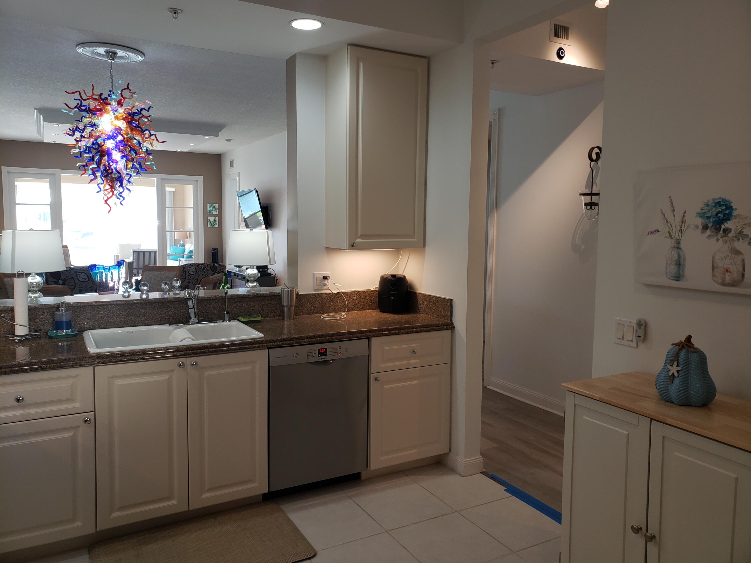 9 Harbour Isle Drive East, Unit 102 Fort Pierce, FL 34949 - Photo 5 of 30 a kitchen with sink cabinets and window