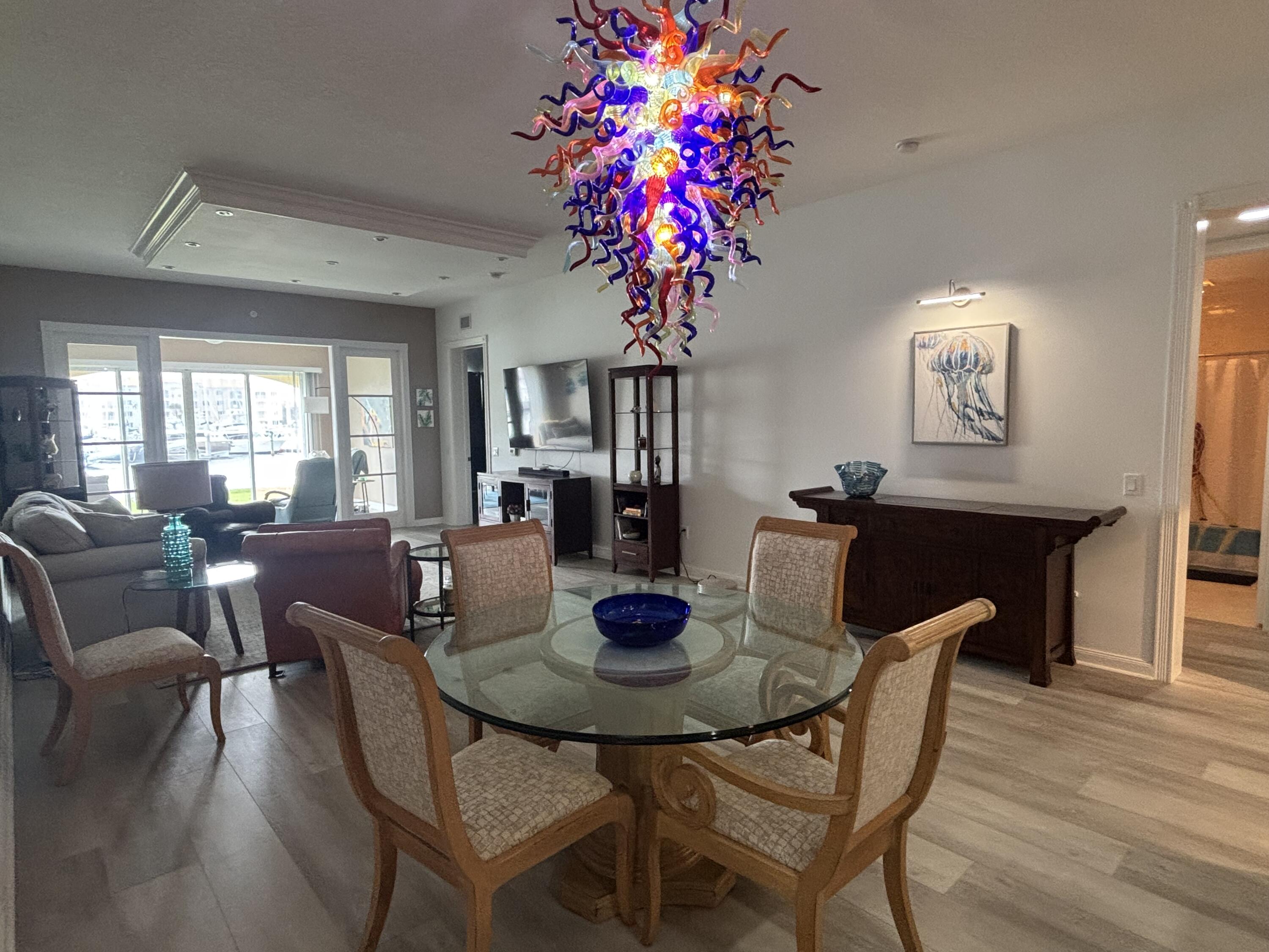9 Harbour Isle Drive East, Unit 102 Fort Pierce, FL 34949 - Photo 10 of 30 a view of a dining room with furniture and chandelier