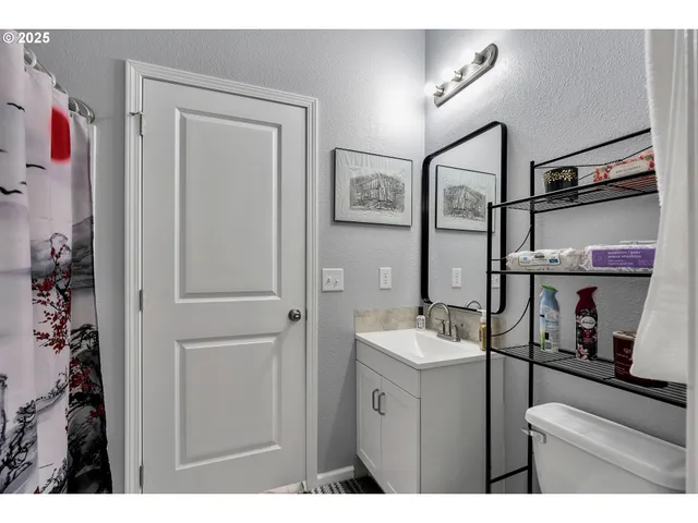 a bathroom with a sink vanity and mirror