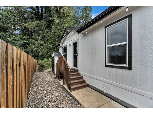 a backyard of a house with wooden floor and stairs